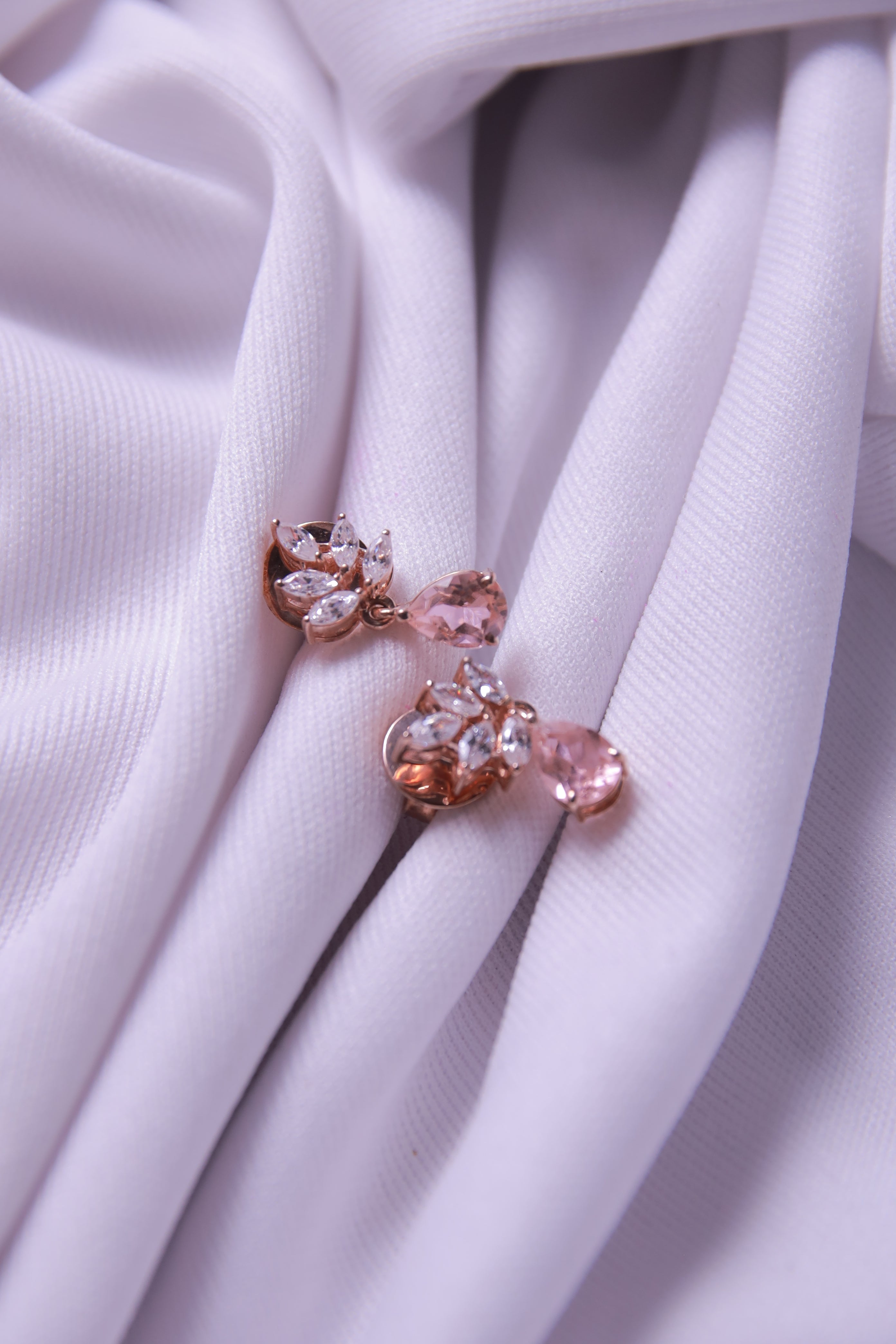 A close-up of Peach Teardrop Earrings, highlighting their smooth finish.