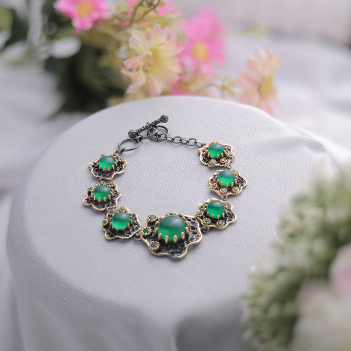 A Green Onyx Bracelet with a sleek and polished finish.