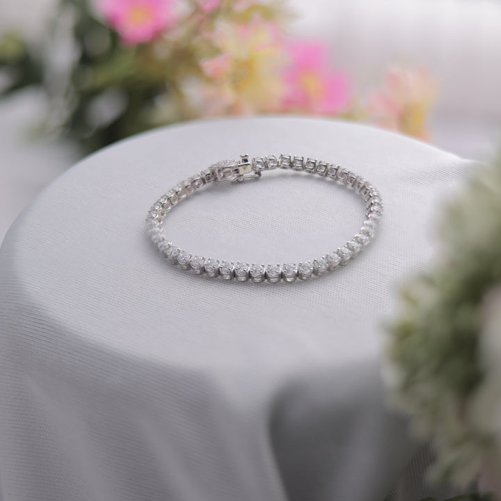 A Swarovski Tennis Bracelet, reflecting brilliant light.