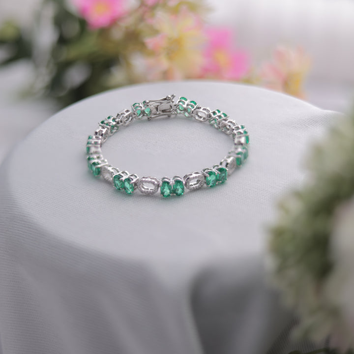 A Green Oval Cut Bracelet sparkling under soft lighting.
