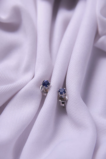 A pair of Dark Blue Sterling Silver Stud Earrings, featuring a rich dark blue gemstone.