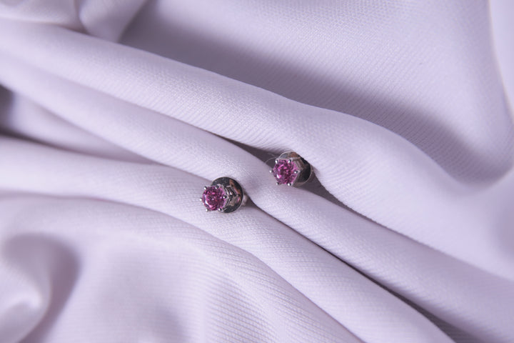 A pair of Dark Pink Sterling Silver Stud Earrings, featuring a sleek and polished design.
