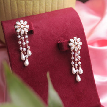 A sparkling pair of Rose Gold Plated Swarovski Diamond & Pearl Earrings in a glamorous design.