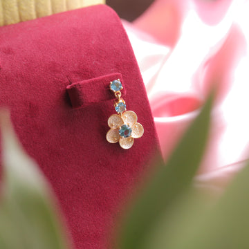 London Blue Topaz Floral Earrings, highlighting their floral elegance.
