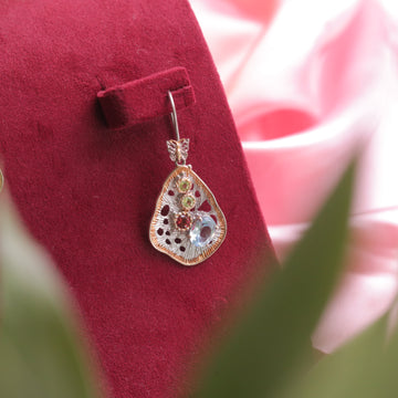 Kaizi Peridot Garnet Topaz Earrings, enhancing her elegant look.