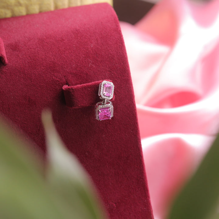 A model wearing Dark Pink Statement Earrings, highlighting their bold design.
