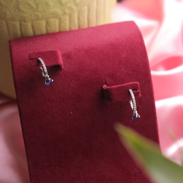 Close-up of a model wearing Blue Hoop Dangling Earrings, highlighting the sleek design