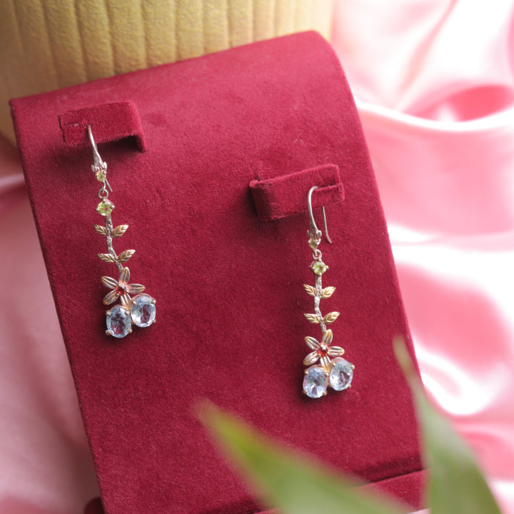 showcasing Kaizi Peridot Topaz Earrings, adding a vibrant touch.