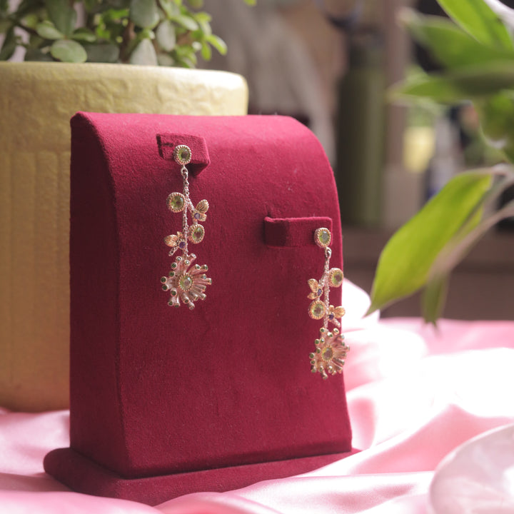 A pair of Kaizi Peridot Earrings with a rich green gemstone.