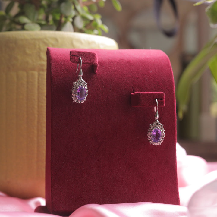 A stunning pair of Kaizi Amethyst Earrings (Violet) with a deep gemstone glow.