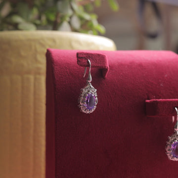 A close-up of Kaizi Amethyst Earrings, highlighting the intricate silver detailing.