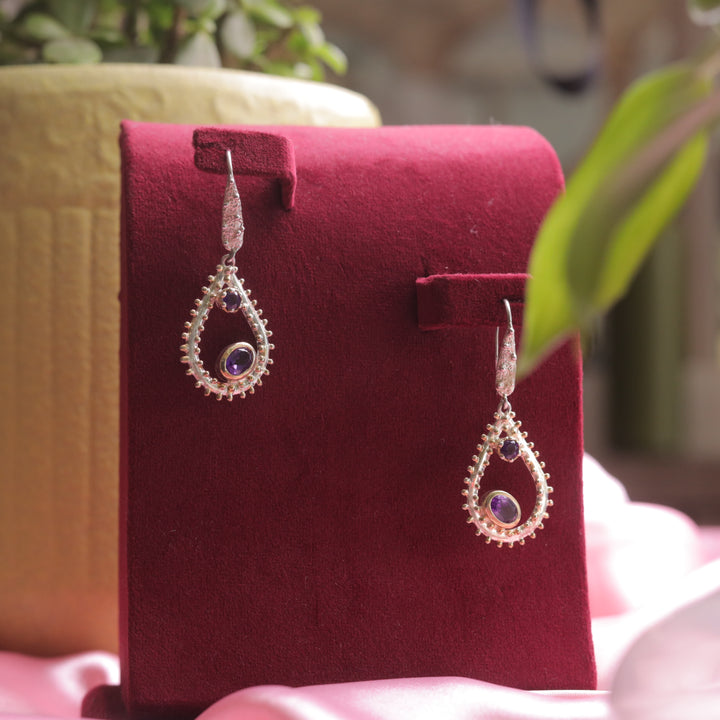 A close-up of Kaizi Natural Amethyst Earrings, showcasing their deep purple gemstone.