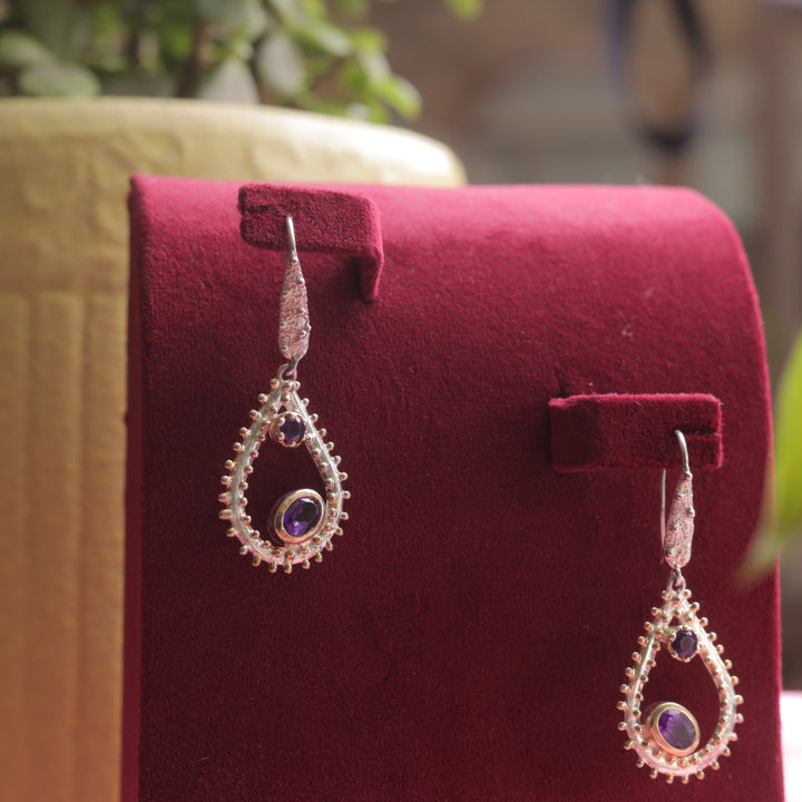 Kaizi Natural Amethyst Earrings, enhancing her elegant style.
